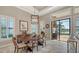 Open dining area with tile floors, plantation shutters, and natural light overlooking the lanai at 7213 Whittlebury Trl, Lakewood Ranch, FL 34202