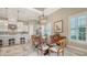 Dining space with chandelier and adjacent island kitchen and stainless steel appliances at 7213 Whittlebury Trl, Lakewood Ranch, FL 34202