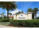 Hazeltine community entrance sign featuring lush landscaping, palm trees, and clear blue skies at 7213 Whittlebury Trl, Lakewood Ranch, FL 34202