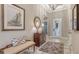 Welcoming foyer with tiled floors, bench seating, decorative lighting, and a glass paneled front door at 7213 Whittlebury Trl, Lakewood Ranch, FL 34202