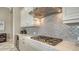 Close up of the bright kitchen featuring a stainless steel range hood and stylish tile backsplash at 7213 Whittlebury Trl, Lakewood Ranch, FL 34202
