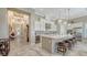 Spacious kitchen with a large island, white cabinets, stainless steel appliances, and bar stool seating at 7213 Whittlebury Trl, Bradenton, FL 34202