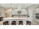 Well-lit kitchen featuring a large center island, stainless appliances, and pendant lighting at 7213 Whittlebury Trl, Lakewood Ranch, FL 34202