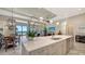 Open concept kitchen with a large island, stainless steel appliances, and views of the living area at 7213 Whittlebury Trl, Lakewood Ranch, FL 34202