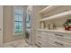 Well-organized laundry room features a stacked washer/dryer and plenty of storage space at 7213 Whittlebury Trl, Lakewood Ranch, FL 34202