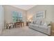Comfortable living room features a cozy sofa, shutters, and neutral decor at 7213 Whittlebury Trl, Lakewood Ranch, FL 34202