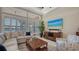 Relaxing living room with coastal accents, a sectional sofa, and views of the water at 7213 Whittlebury Trl, Lakewood Ranch, FL 34202