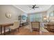 Comfortable living room with wood floors, a ceiling fan, and a large window with plantation shutters at 7213 Whittlebury Trl, Lakewood Ranch, FL 34202
