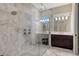 Modern main bathroom boasts a large glass shower with dual shower heads and marble countertops at 7213 Whittlebury Trl, Lakewood Ranch, FL 34202