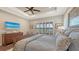 Bright main bedroom with hardwood floors, a ceiling fan, and large windows with plantation shutters at 7213 Whittlebury Trl, Lakewood Ranch, FL 34202