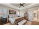 Spacious main bedroom features a tray ceiling, plantation shutters, and elegant wood furnishings at 7213 Whittlebury Trl, Lakewood Ranch, FL 34202