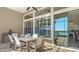 Elegant outdoor dining area featuring sleek furniture, views of the lake, and ample natural light at 7213 Whittlebury Trl, Lakewood Ranch, FL 34202