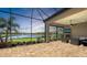 Enjoy lake views on this spacious patio with stone fireplace and outdoor seating area at 7213 Whittlebury Trl, Lakewood Ranch, FL 34202
