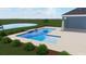 An outdoor pool with cool, clear blue water is surrounded by a stone deck and tropical plants and greenery at 7213 Whittlebury Trl, Lakewood Ranch, FL 34202