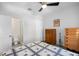 Bright bedroom featuring ceiling fan, two dressers, and an attached bathroom with glass shower at 7317 Emma Rd, Bradenton, FL 34209