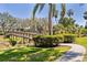 Charming wooden bridge spanning a serene waterway, surrounded by lush greenery and swaying palm trees at 7317 Emma Rd, Bradenton, FL 34209