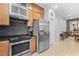 Modern kitchen with stainless steel appliances, stylish backsplash, and a cozy dining area at 7317 Emma Rd, Bradenton, FL 34209