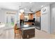 Modern kitchen features a black countertop island, wood cabinets, and stainless-steel appliances at 7317 Emma Rd, Bradenton, FL 34209