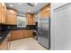 Well-equipped kitchen with stainless steel appliances, wood cabinets, and a bright, airy feel at 7317 Emma Rd, Bradenton, FL 34209