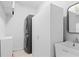 Well lit laundry room featuring stacked washer and dryer along with built in sink at 7317 Emma Rd, Bradenton, FL 34209