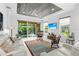 Open-concept living room featuring sliding glass doors to an outdoor patio and comfortable seating at 7317 Emma Rd, Bradenton, FL 34209