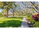 Scenic community park featuring a walking path, playground, lush lawns, and mature trees at 7317 Emma Rd, Bradenton, FL 34209