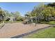 Community playground featuring a climbing wall and other play structures, all surrounded by lush greenery at 7317 Emma Rd, Bradenton, FL 34209