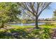 Beautiful pond with waterfront homes, lush greenery, and clear blue sky creating a scenic backdrop at 7317 Emma Rd, Bradenton, FL 34209