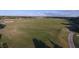 Aerial view of golfers practicing on a lush green golf course at 7327 Greystone St, Lakewood Ranch, FL 34202