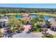 Aerial view of the home, showcasing the lush landscaping, nearby pond, and golf course at 7327 Greystone St, Lakewood Ranch, FL 34202