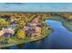 Waterfront property with golf course view features a screened lanai with a pool at 7327 Greystone St, Lakewood Ranch, FL 34202