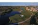 Scenic aerial view of a golf course, lake, and nearby houses at 7327 Greystone St, Lakewood Ranch, FL 34202
