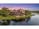 An elevated rear view shows the pool and covered patio and the home's proximity to the water at 7327 Greystone St, Lakewood Ranch, FL 34202