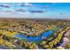 An aerial view shows the neighborhood and the home's location on a pond, close to a golf course at 7327 Greystone St, Lakewood Ranch, FL 34202