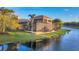 Waterfront home features a screened lanai with a pool overlooking a tranquil lake at 7327 Greystone St, Lakewood Ranch, FL 34202