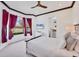 Bright bedroom features a bed, bay windows with an outdoor view, and tray ceiling with wood accents at 7327 Greystone St, Lakewood Ranch, FL 34202