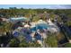 Inviting aerial view of the community pool area, complete with comfortable loungers and lush palm trees for relaxation at 7327 Greystone St, Lakewood Ranch, FL 34202