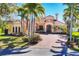 Mediterranean-style home with manicured landscaping, a paver drive, and a tile roof at 7327 Greystone St, Lakewood Ranch, FL 34202