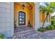 Inviting front entrance featuring a custom door, stone accents, and colorful brick steps at 7327 Greystone St, Lakewood Ranch, FL 34202