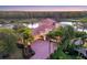 A beautiful home boasts a paver driveway, a tile roof, and mature landscaping at 7327 Greystone St, Lakewood Ranch, FL 34202