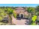 A beautiful home boasts a paver driveway and well-manicured landscaping at 7327 Greystone St, Lakewood Ranch, FL 34202