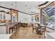 Gourmet kitchen and dining area with custom brickwork and direct access to an enclosed outdoor space at 7327 Greystone St, Lakewood Ranch, FL 34202