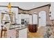 Spacious kitchen featuring brick accents, modern appliances, and a stylish island with granite countertops at 7327 Greystone St, Lakewood Ranch, FL 34202