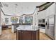 Open concept kitchen with modern stainless appliances, center island, and a view to screened outdoor space at 7327 Greystone St, Lakewood Ranch, FL 34202