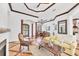 Open living room with custom floors, decorative columns, and a view of the dining room and front entrance at 7327 Greystone St, Lakewood Ranch, FL 34202