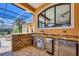 Well-equipped outdoor kitchen boasts granite countertops, stainless steel appliances, and a built-in wine cooler at 7327 Greystone St, Lakewood Ranch, FL 34202