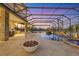 Relaxing screened in pool area with lake views and a fire pit feature at 7327 Greystone St, Lakewood Ranch, FL 34202