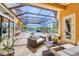 The outdoor living area features a covered patio, outdoor seating, and pool with spa at 7327 Greystone St, Lakewood Ranch, FL 34202
