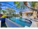 Stunning pool with lush tropical landscaping, and a clear view of the tranquil waterfront at 7327 Greystone St, Lakewood Ranch, FL 34202