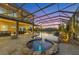 Beautiful pool and hot tub featuring an outdoor kitchen and screened-in enclosure at 7327 Greystone St, Lakewood Ranch, FL 34202
